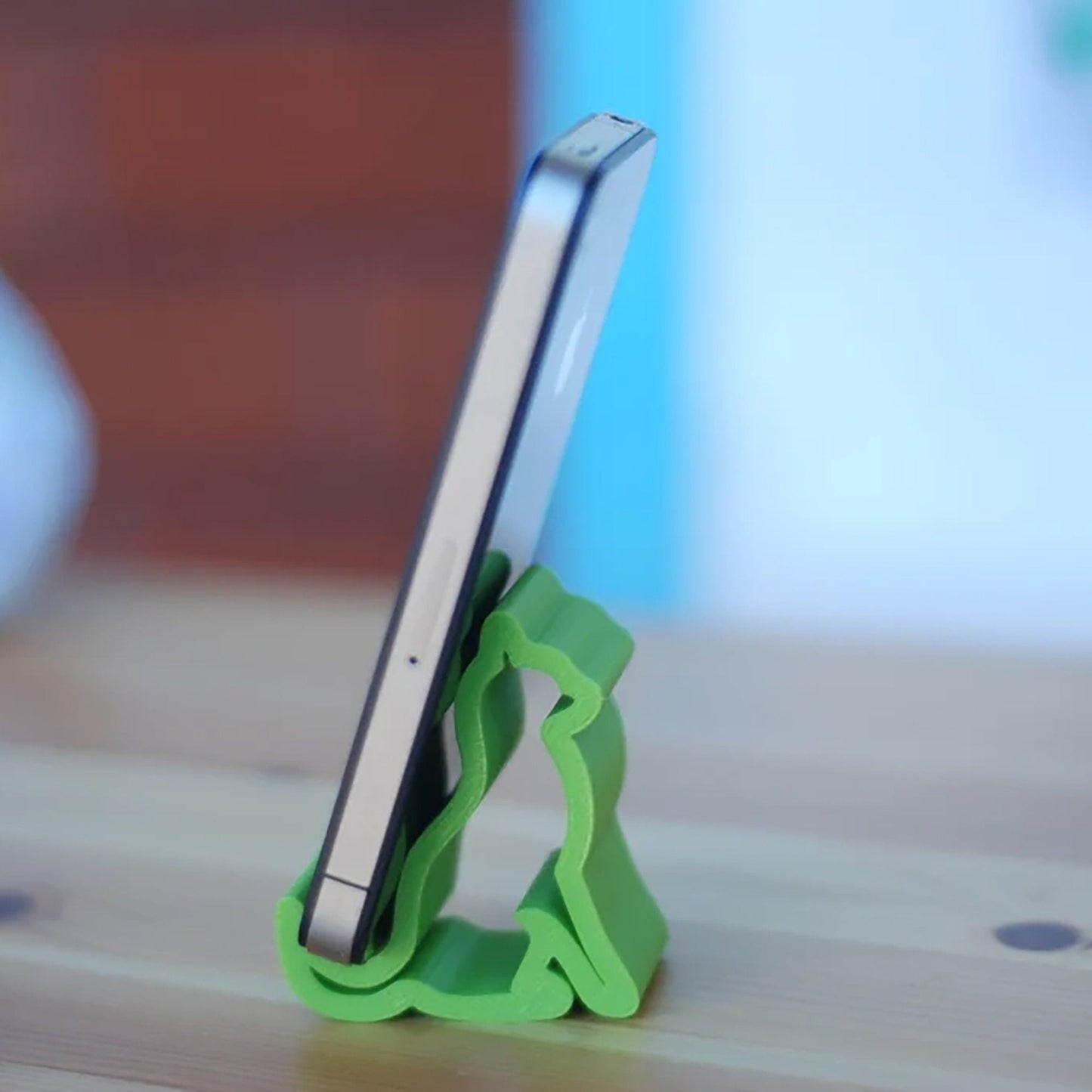 a cell phone holder sitting on top of a wooden table