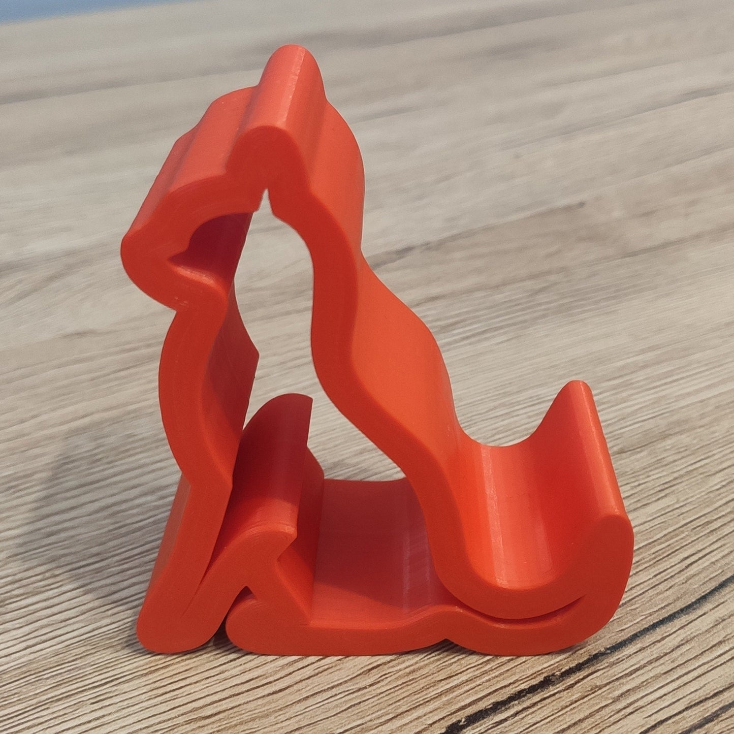 a red object sitting on top of a wooden table