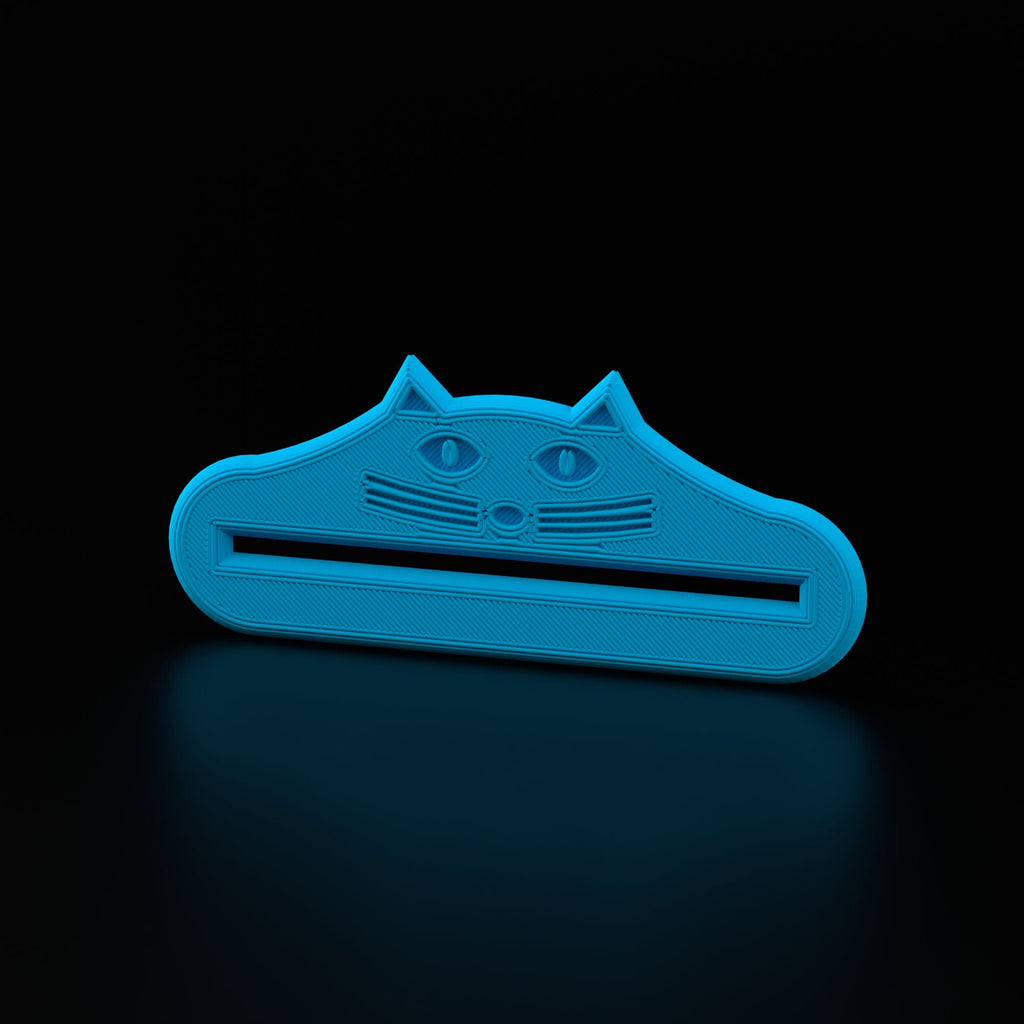 Cat face toothpaste tube squeezer rolling up a toothpaste tube
