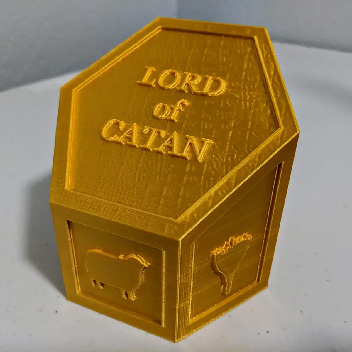 Hexagonal Lord of Catan winner trophy with resource icons for Settlers of Catan game night