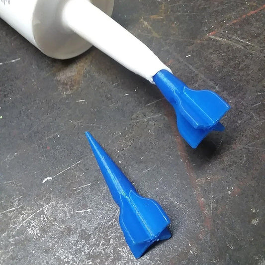 a toothbrush and a tube of toothpaste on a table