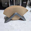 Saddle-shaped coffee filter holder with a stack of No.4 cone paper filters