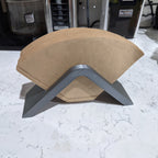 Saddle-shaped coffee filter holder with a stack of No.4 cone paper filters