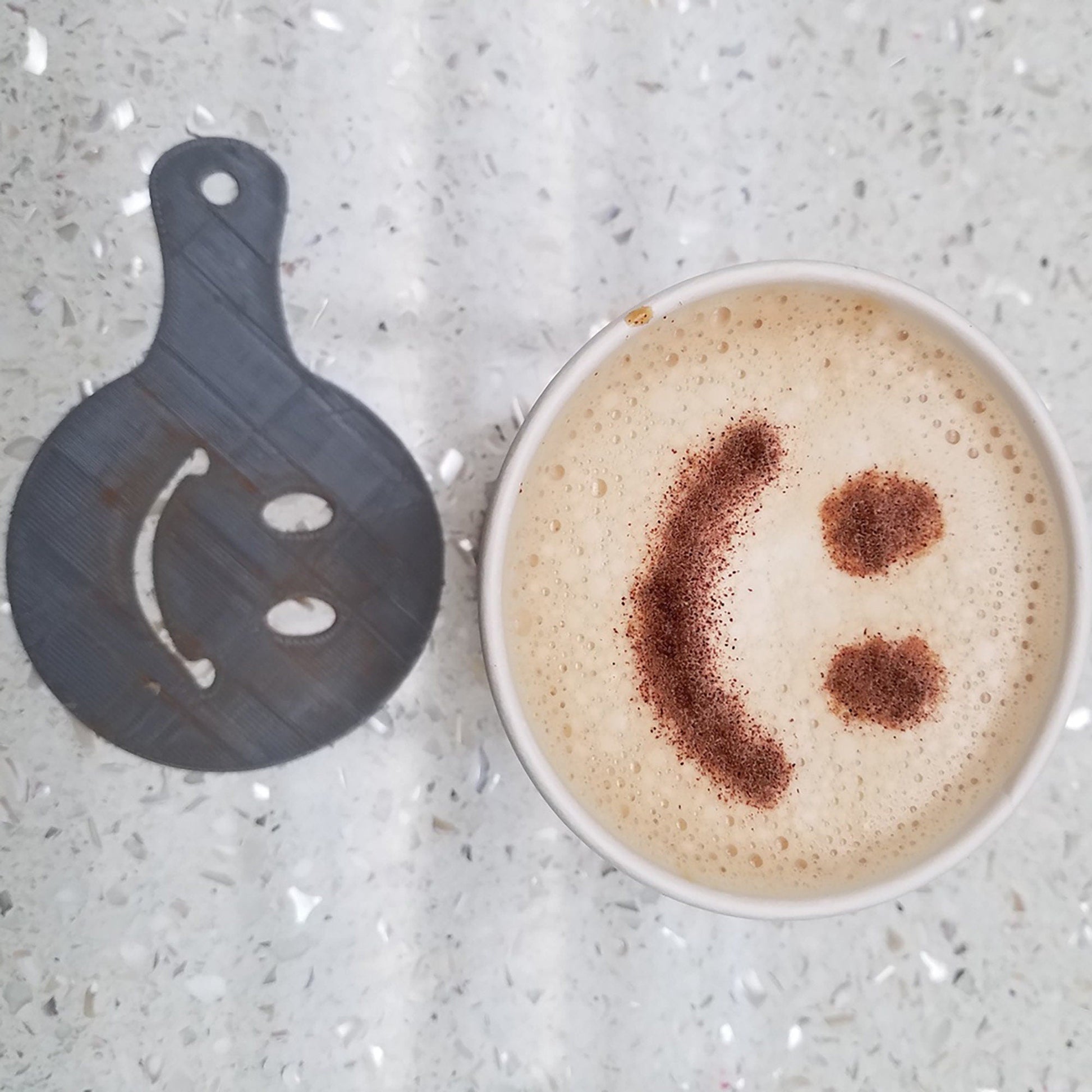 a cup of coffee with a smiley face drawn on it