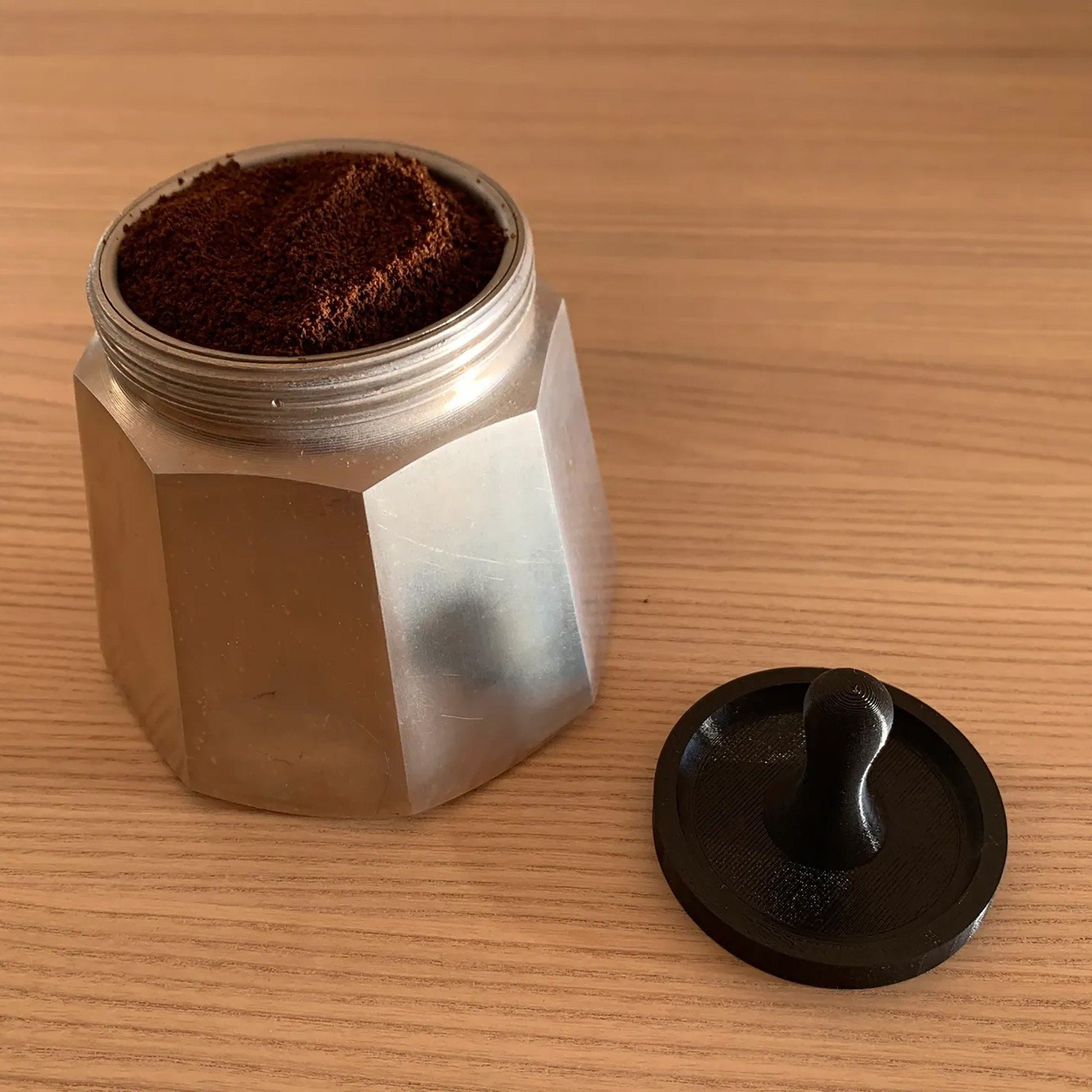 a coffee grinder sitting on top of a wooden table