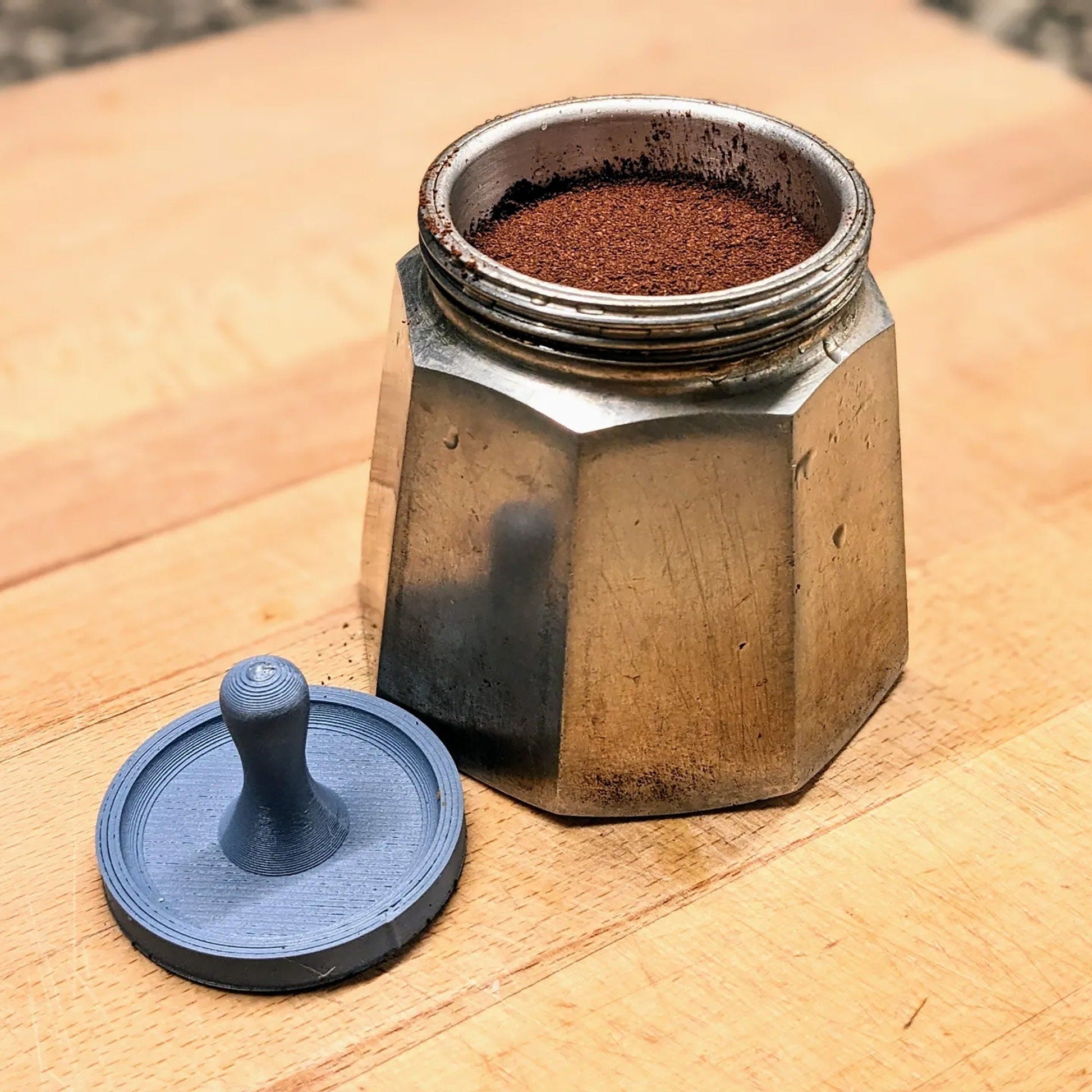 a coffee grinder sitting on top of a wooden table