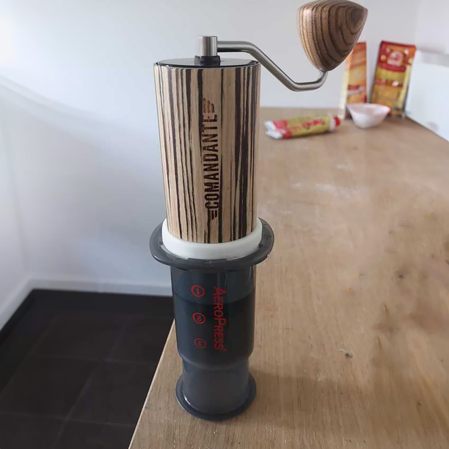 a coffee grinder sitting on top of a wooden table