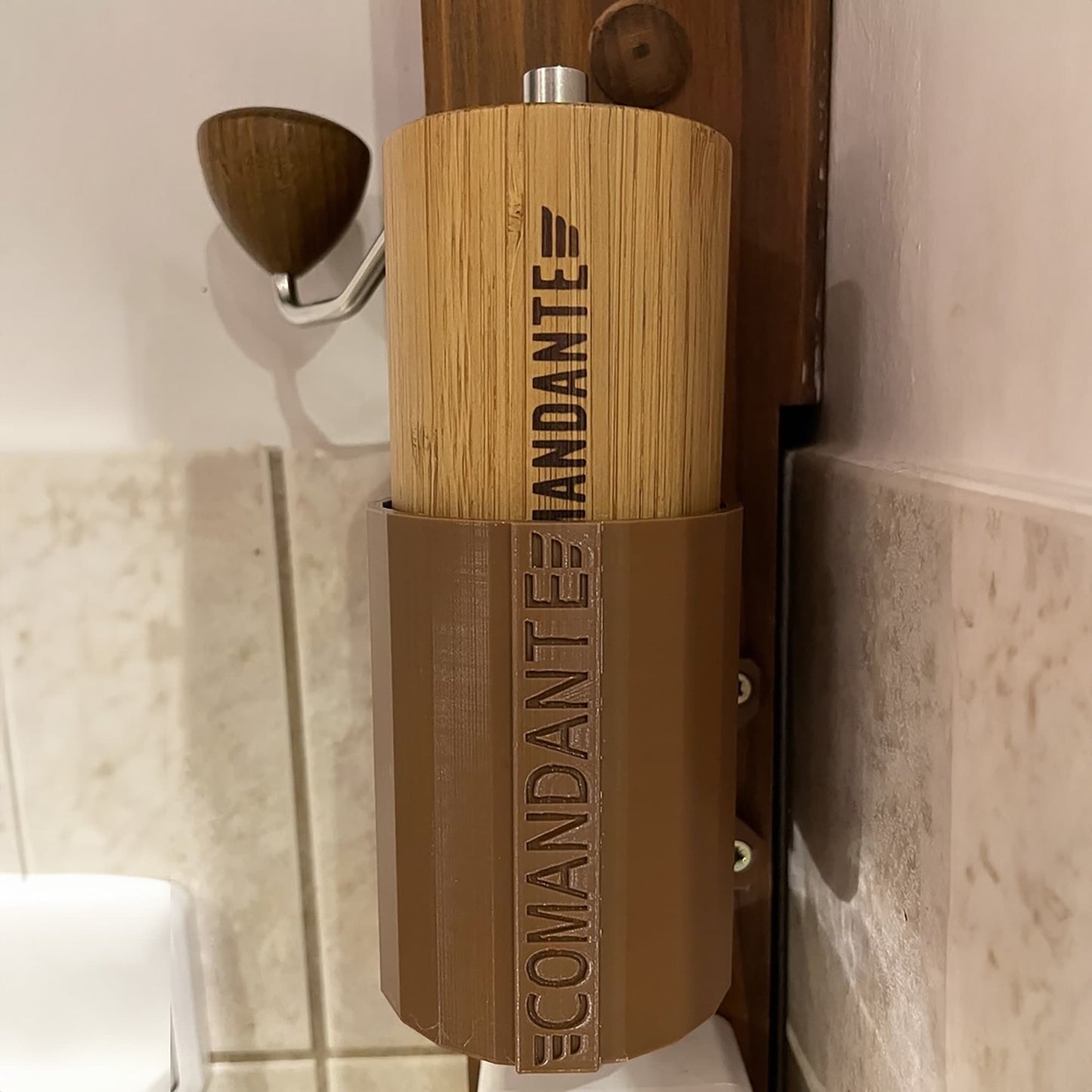 a toilet paper dispenser with a wooden handle