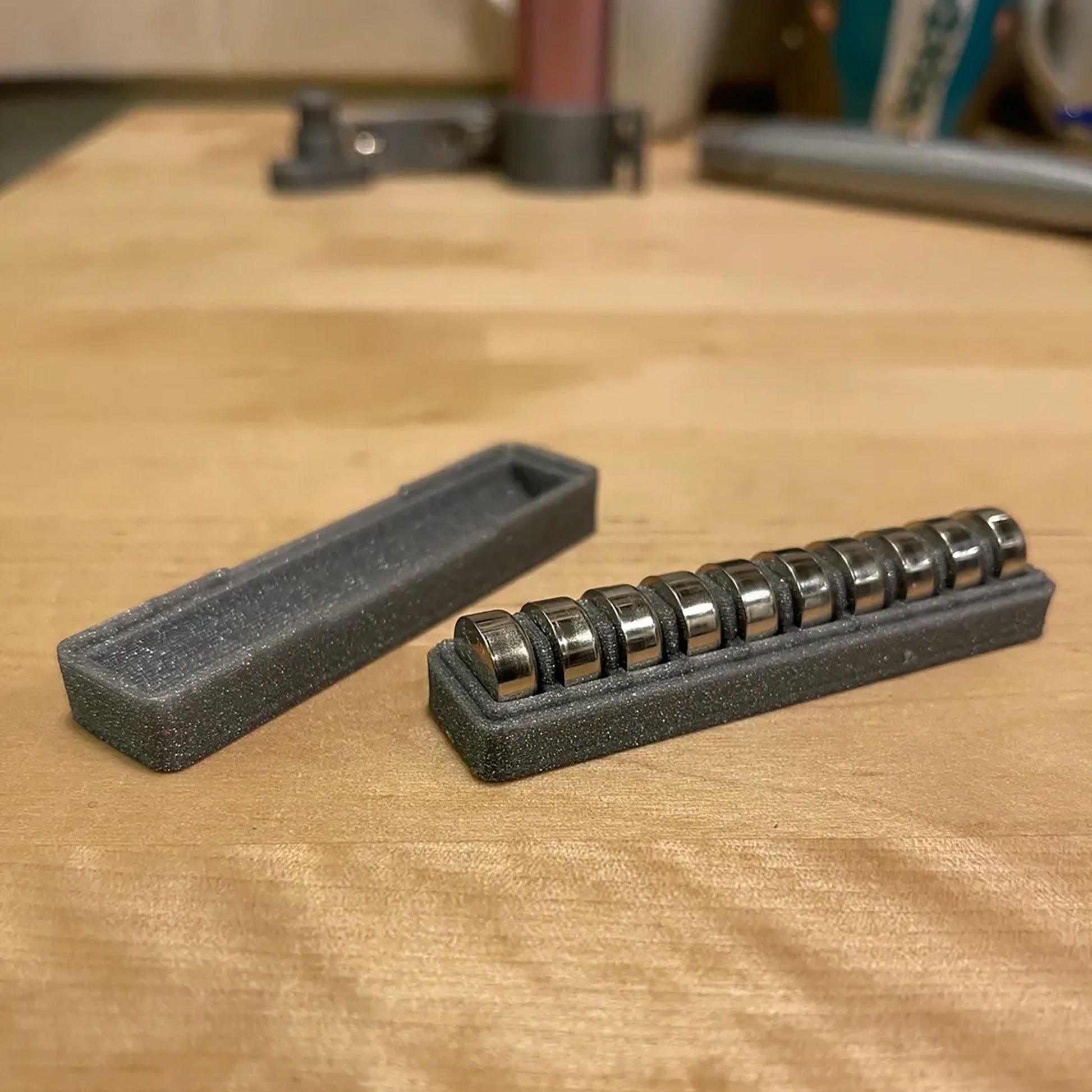 a couple of black keys sitting on top of a wooden table