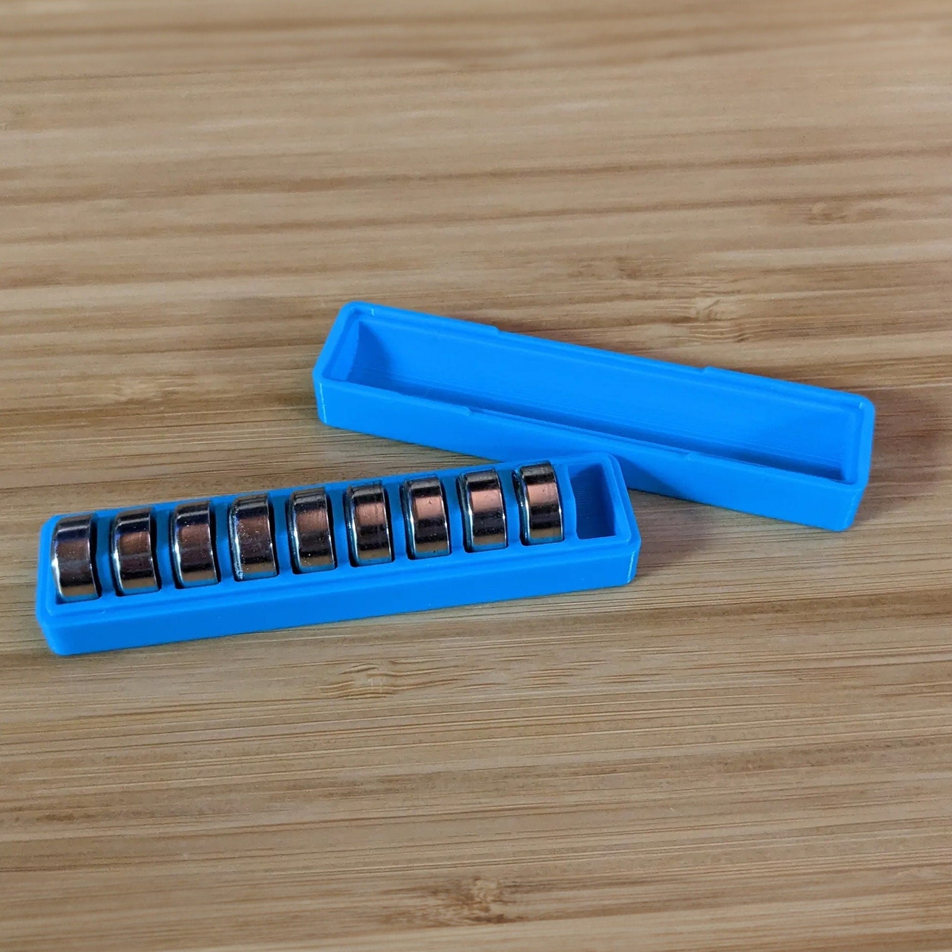 a couple of blue batteries sitting on top of a wooden table