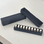 Button cell storage box with slotted insert holding LR44 batteries