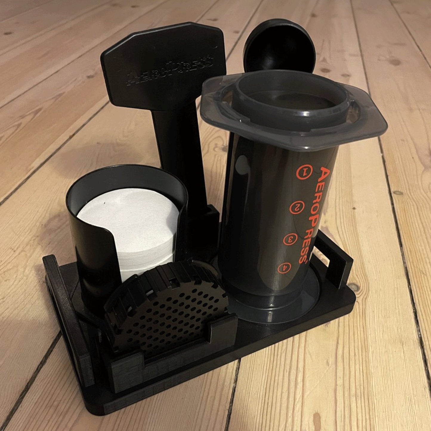 a coffee maker sitting on top of a wooden floor