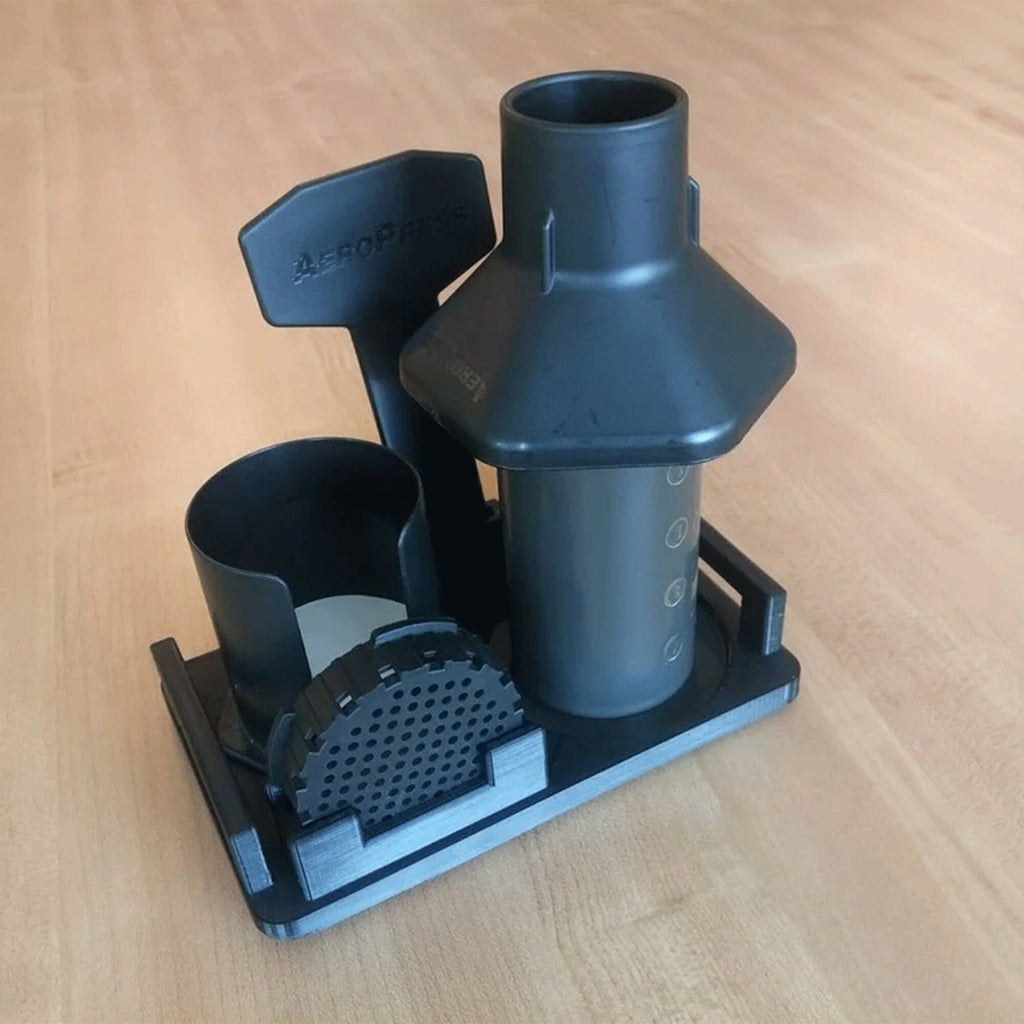 Storage caddy and drying stand holding AeroPress chamber, plunger, funnel and filter cap