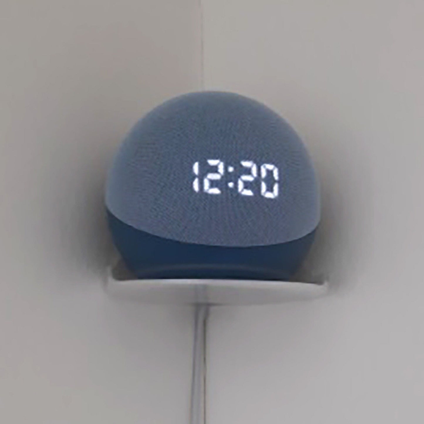 a blue alarm clock on a white wall