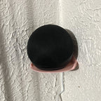 Wall mount cradle holding a spherical Echo Dot smart speaker