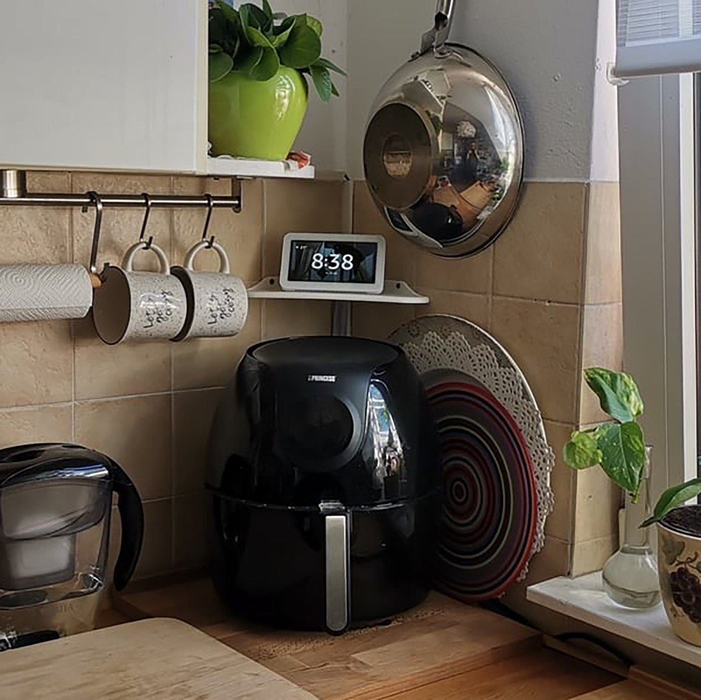 a kitchen counter with a clock and various kitchen items