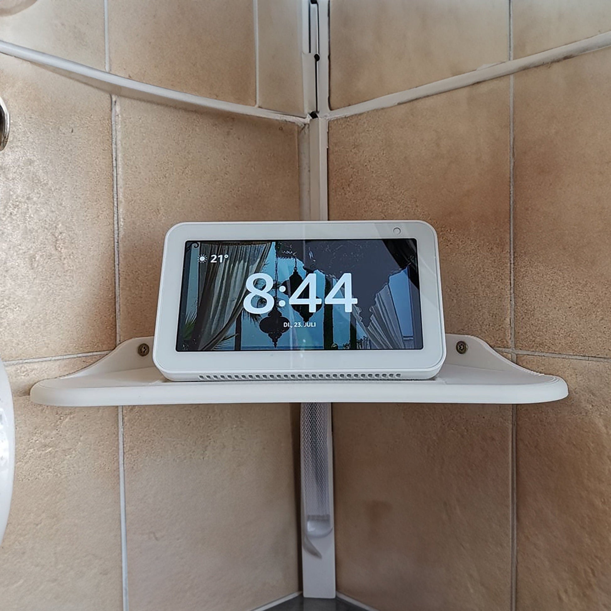 a tablet on a shelf in a bathroom