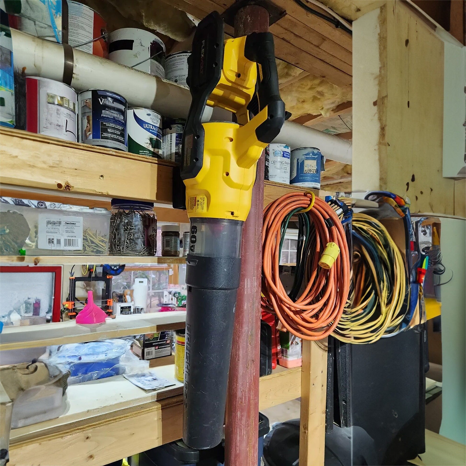 a yellow and black tool is in a garage