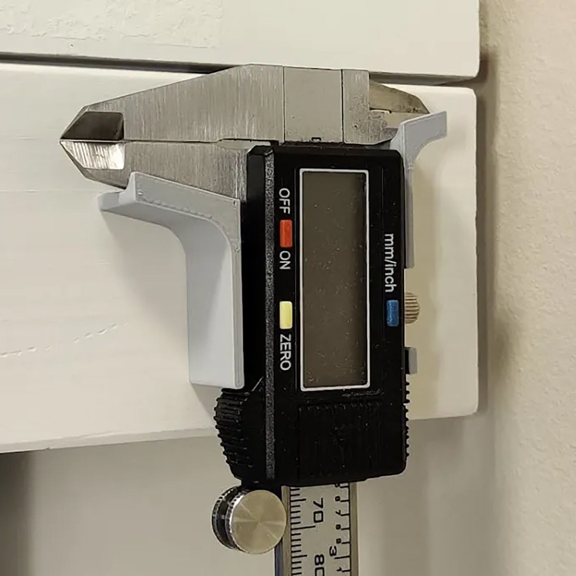 a measuring device attached to a door handle