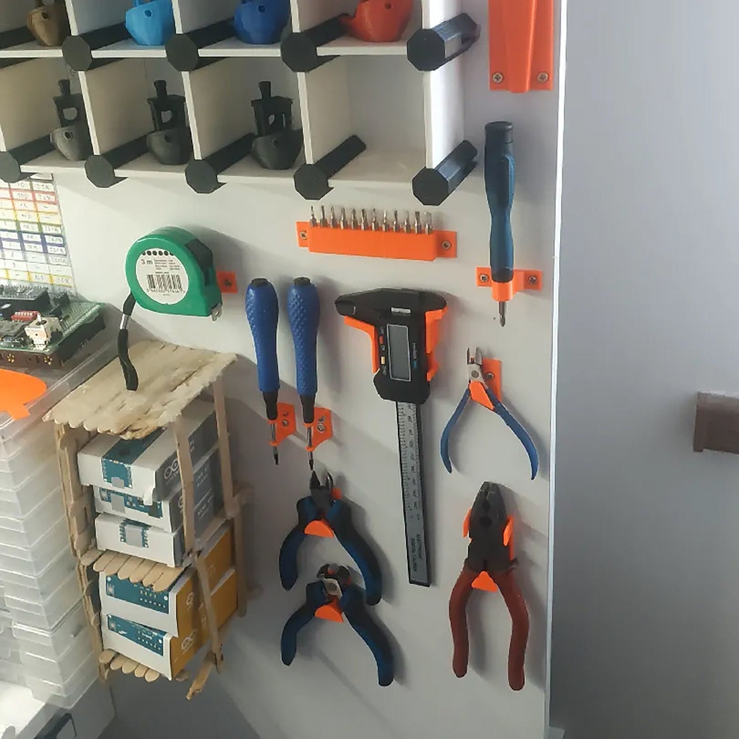 a bunch of tools are hanging on a wall