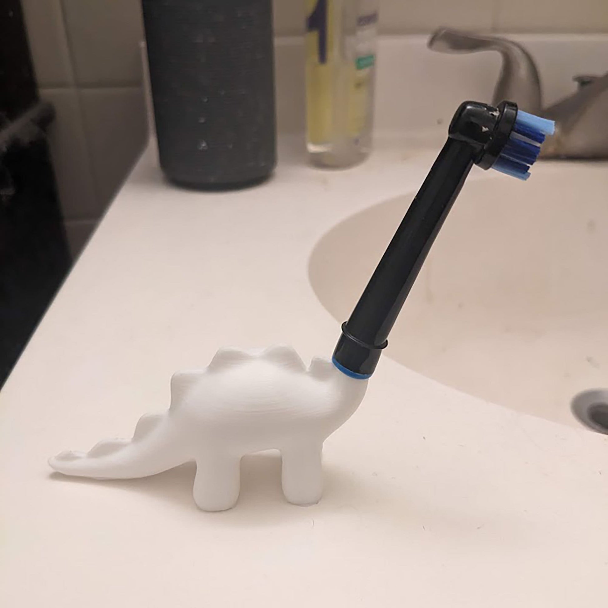 a toothbrush holder sitting on top of a bathroom sink