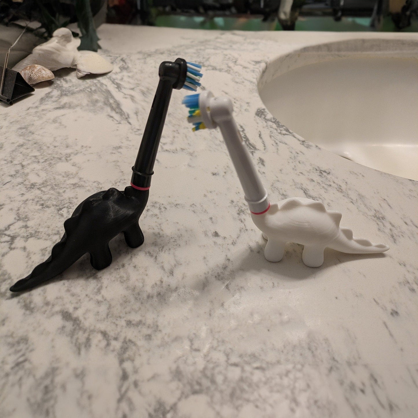 a toothbrush holder sitting on top of a marble counter