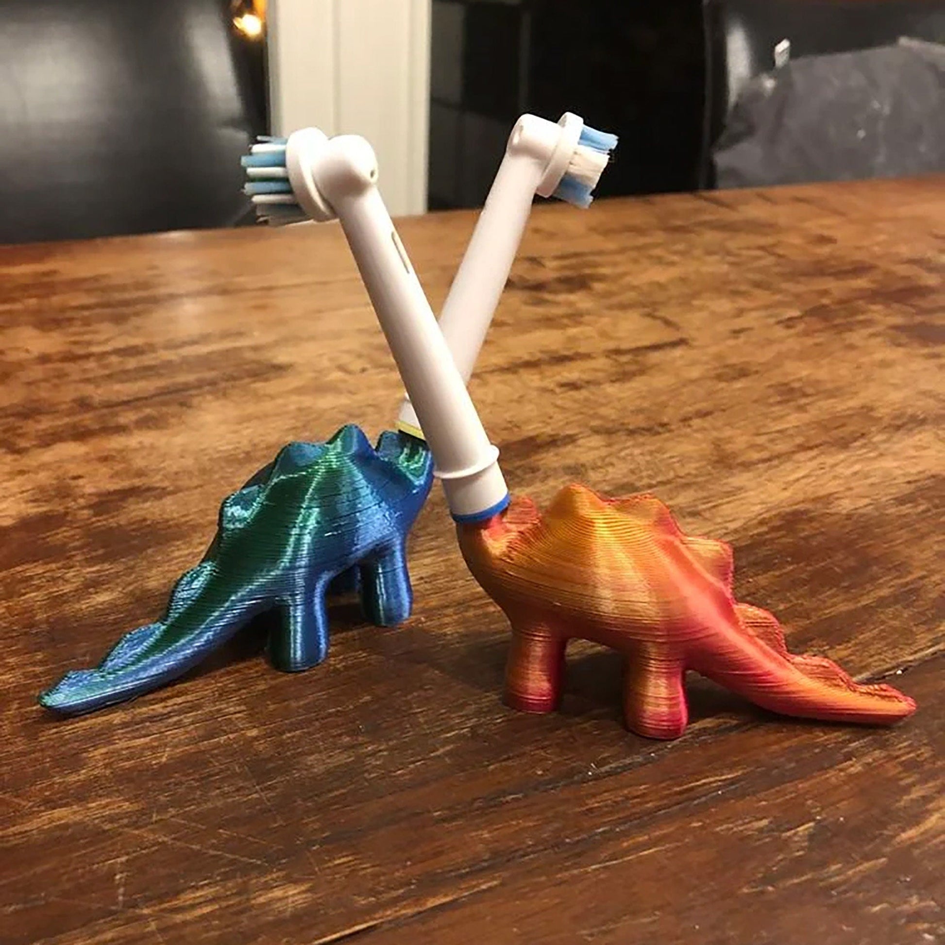 two toothbrushes sitting on top of a wooden table