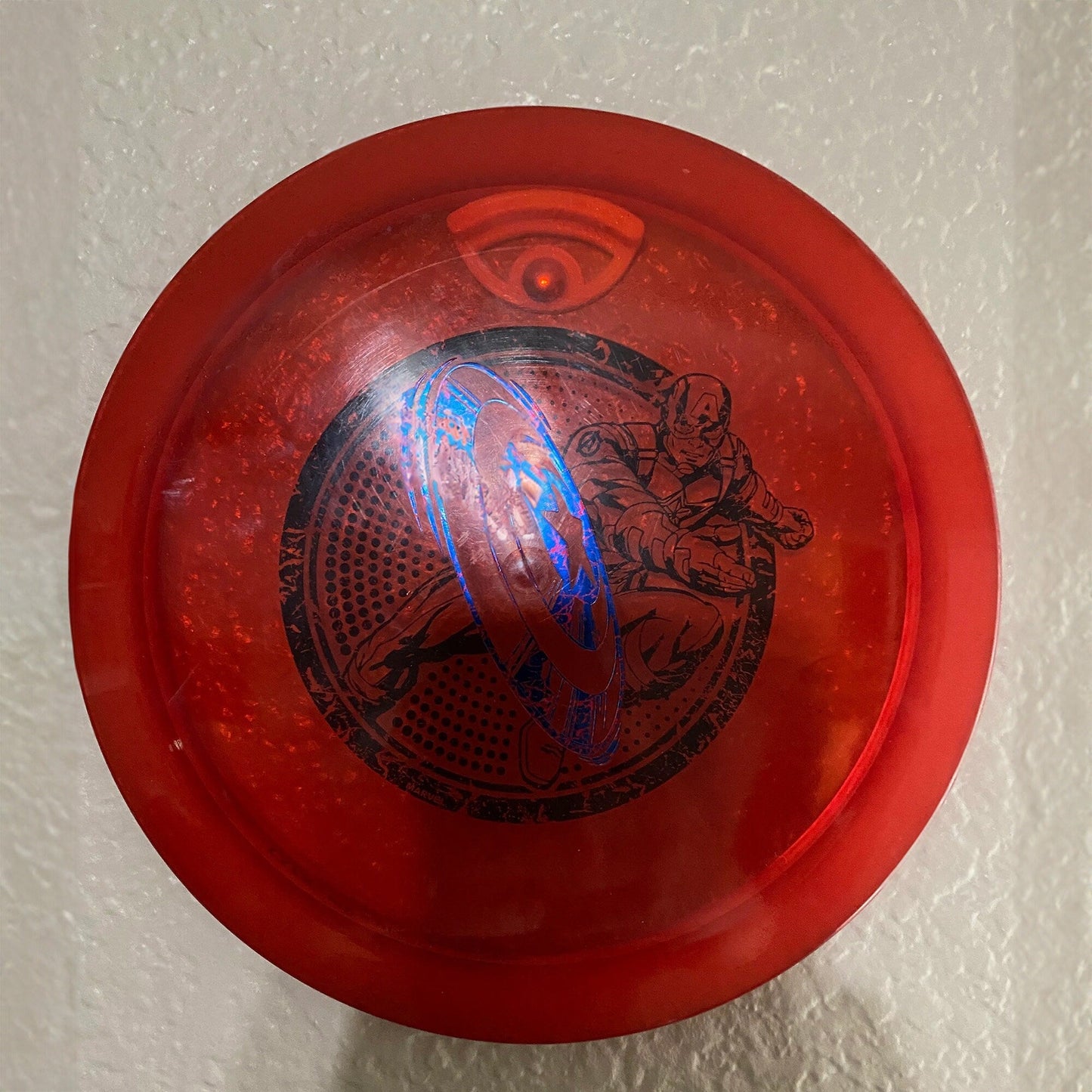 a red frisbee with a picture of a horse on it