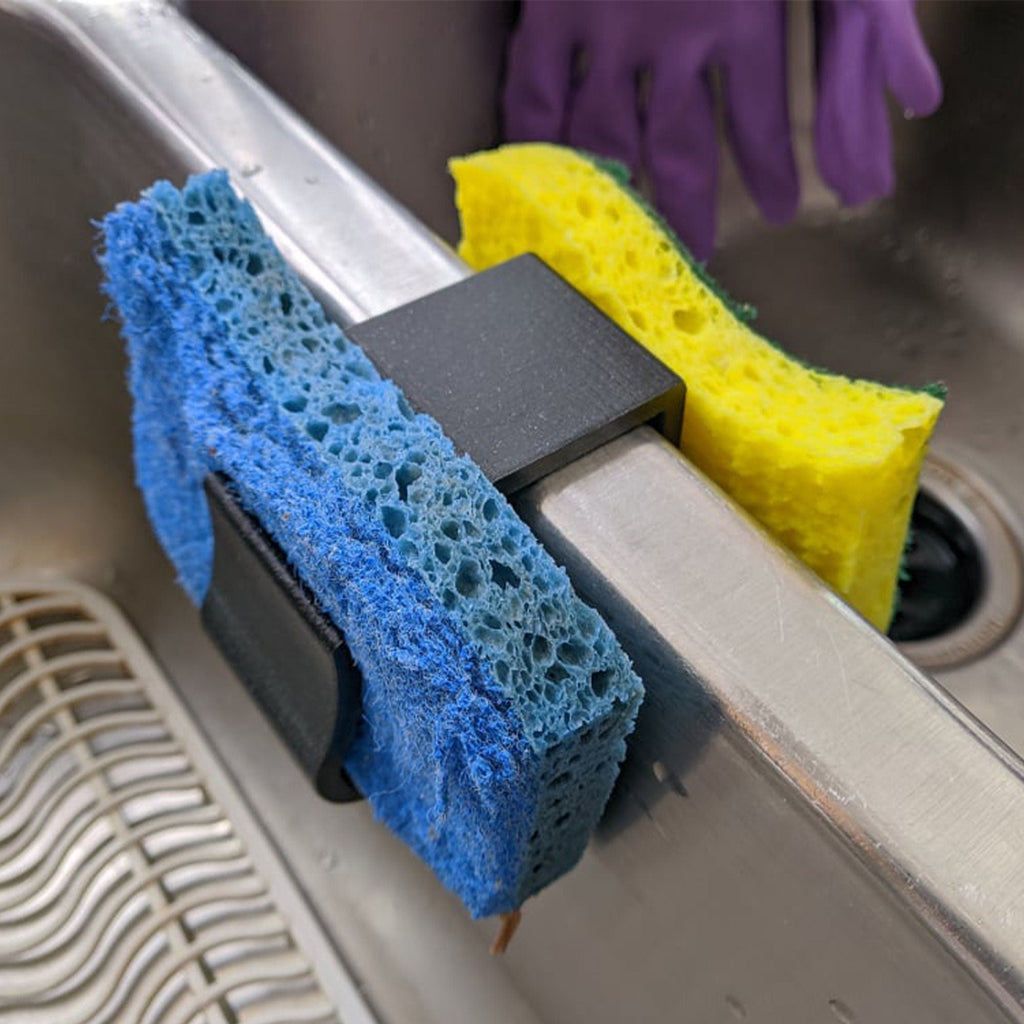 Sponge holder over a double kitchen sink divider holding two sponges, view 2
