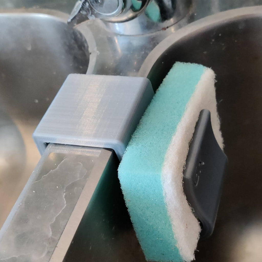 Sponge holder over a double kitchen sink divider holding two sponges, view 3