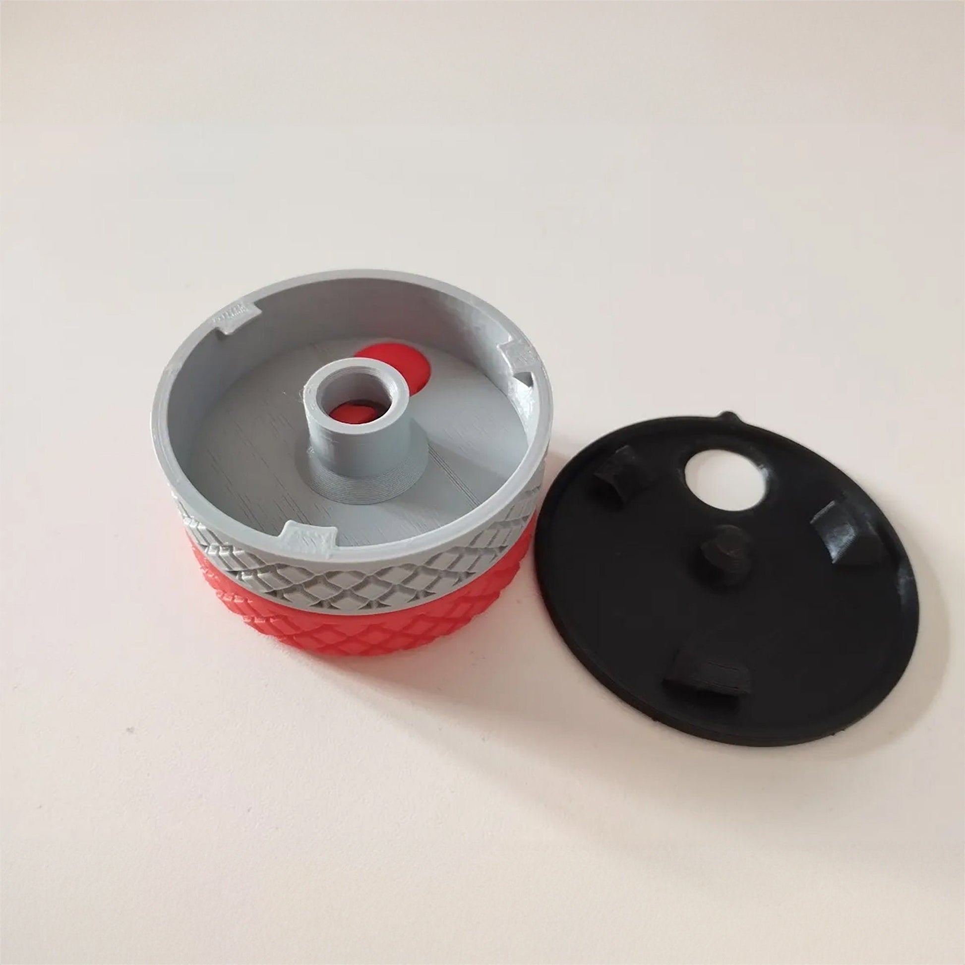 a black and red cup holder next to a white and black cup holder