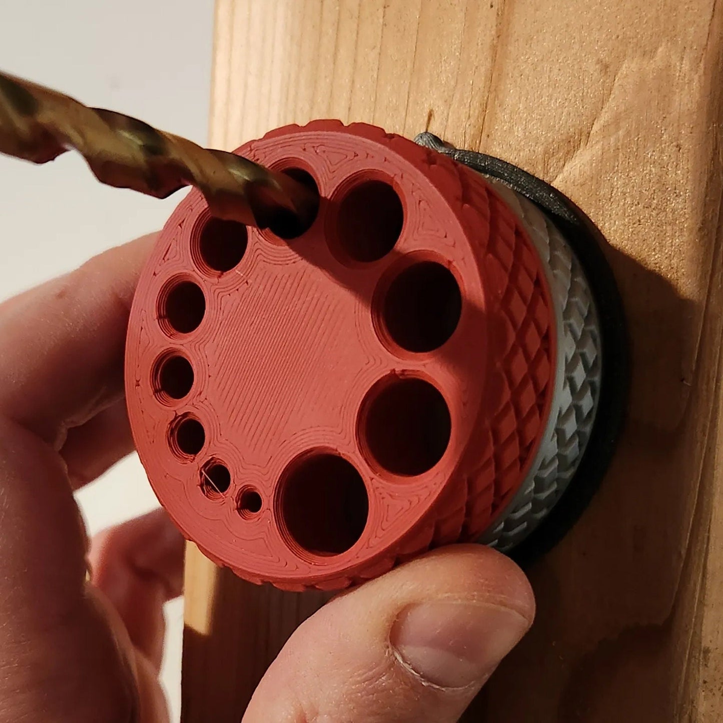 a person using a drill to drill holes in a piece of wood