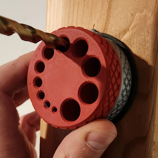 a person using a drill to drill holes in a piece of wood