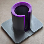 Hair tool stand holding a Dyson Airwrap upright with side cable slot and square base, view 2