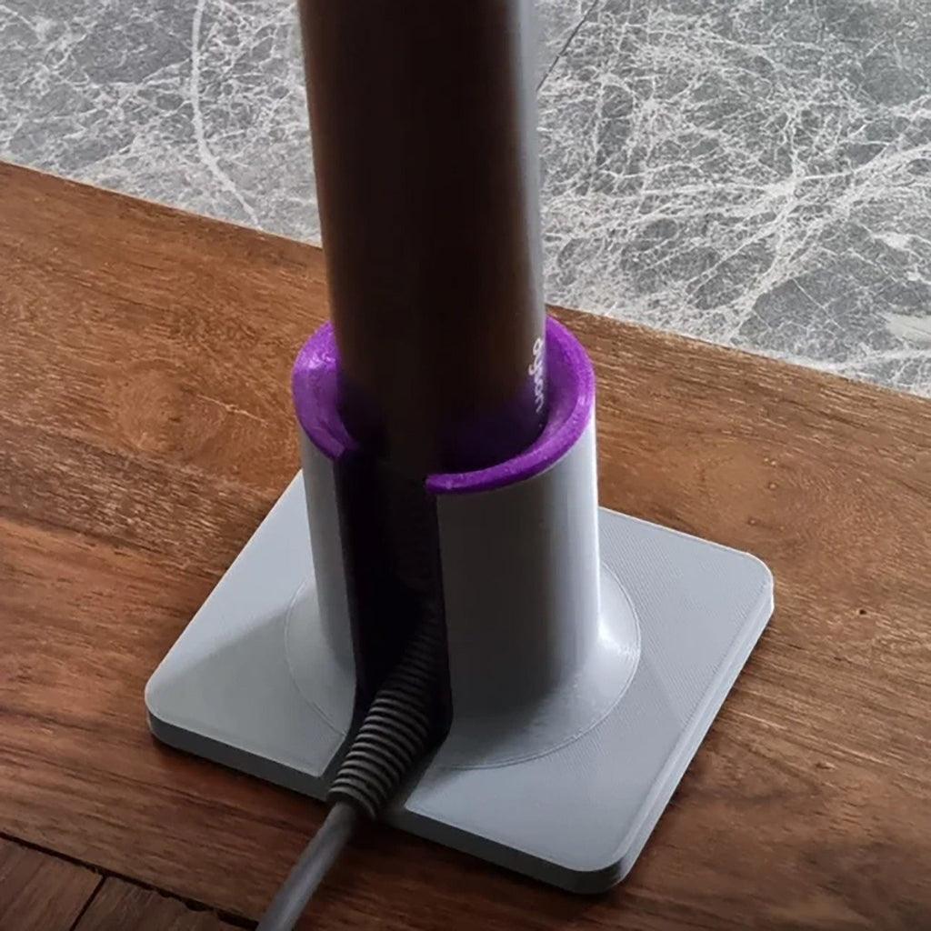 Hair tool stand holding a Dyson Airwrap upright with side cable slot and square base