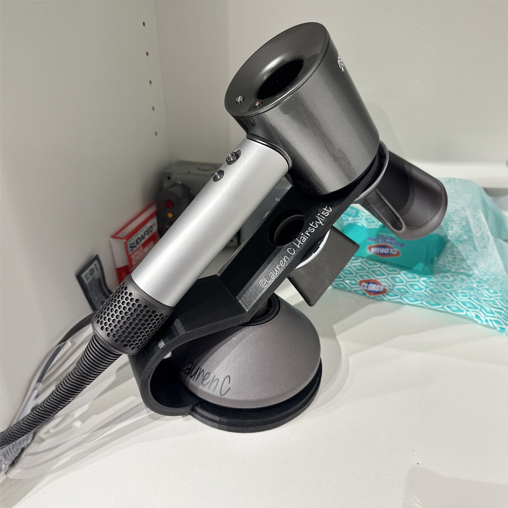 Countertop hair dryer stand with curved arm holding a Dyson Supersonic upright, view 2