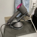 Countertop hair dryer stand with curved arm holding a Dyson Supersonic upright, view 3