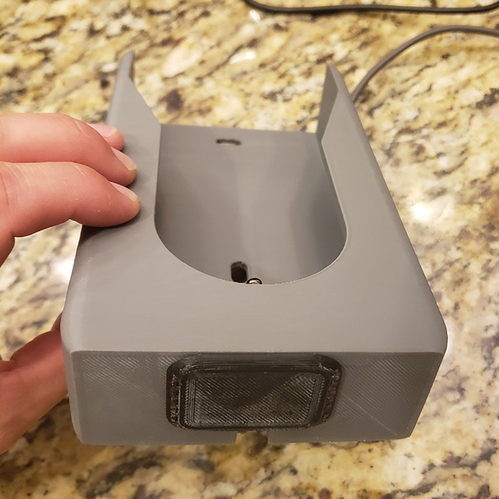 Wall mount charging dock holding a spare Dyson V8 to V15 battery and handle, view 2