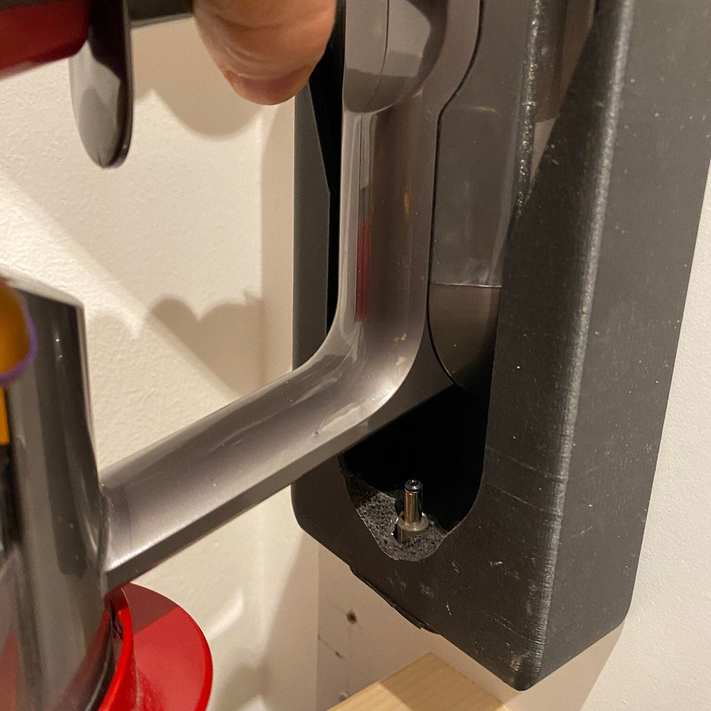 Wall mount charging dock holding a spare Dyson V8 to V15 battery and handle, view 3
