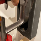 Wall mount charging dock holding a spare Dyson V8 to V15 battery and handle, view 3