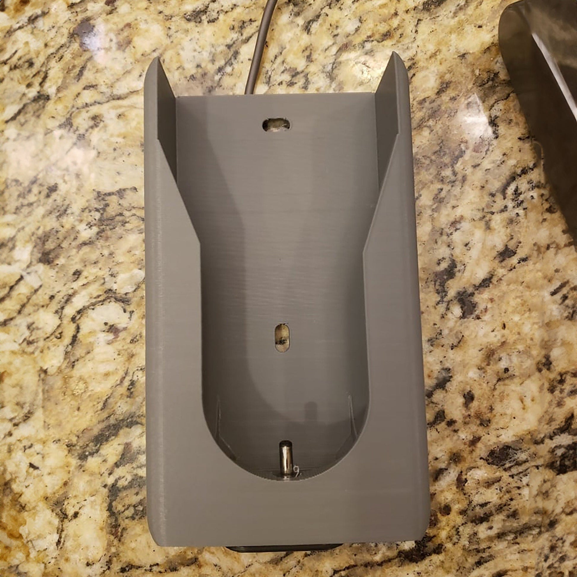 a gray mouse sitting on top of a counter