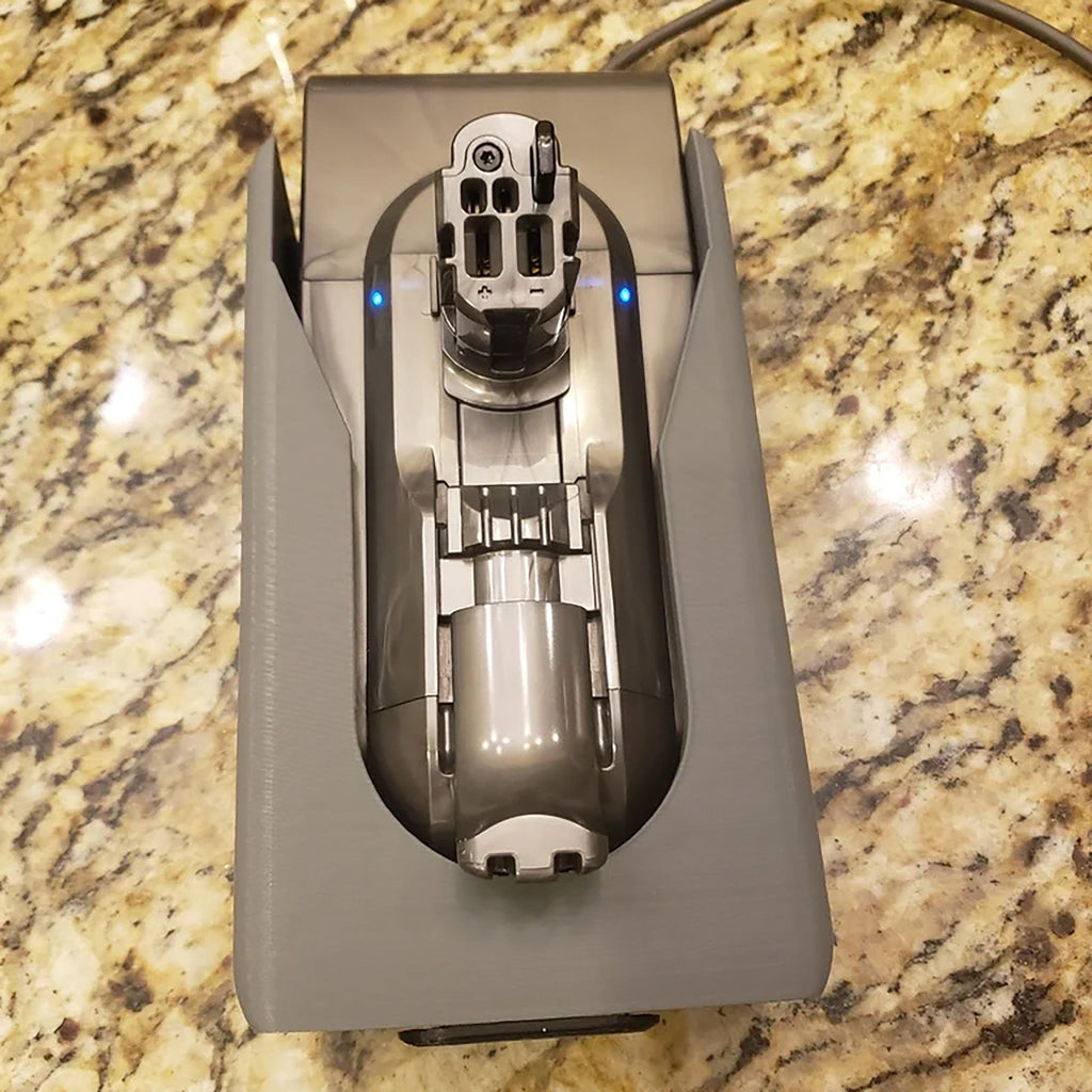 Wall mount charging dock holding a spare Dyson V8 to V15 battery and handle