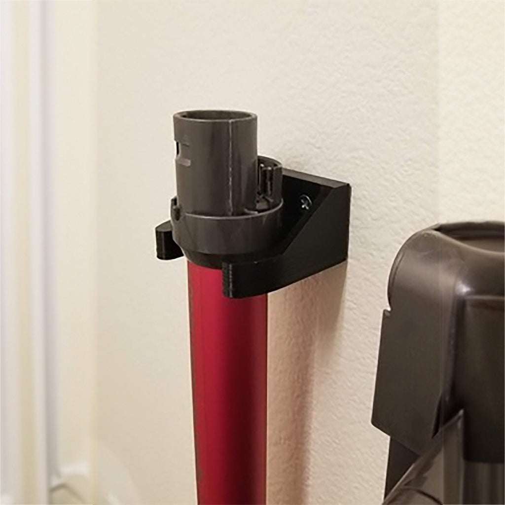 Wall mount wand holder storing a Dyson stick vacuum extension tube upright, view 2