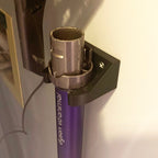 Wall mount wand holder storing a Dyson stick vacuum extension tube upright, view 5