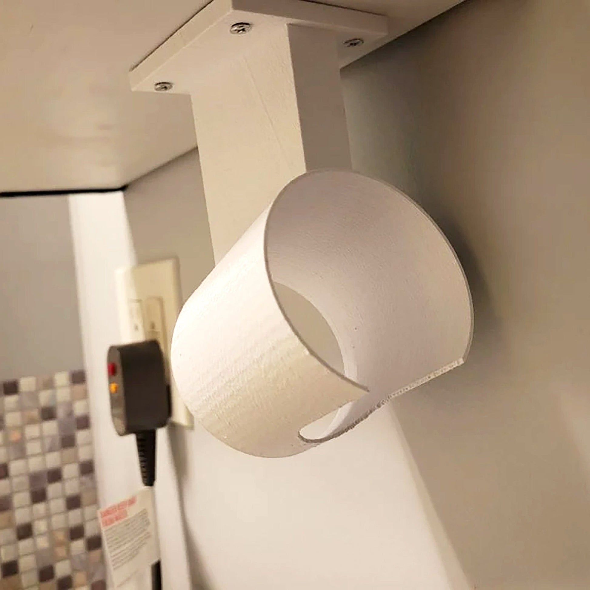 a toilet paper roll hanging from a wall