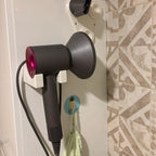 Bathroom wall mount holder for Dyson Supersonic hair dryer with cord routed down the wall, view 3