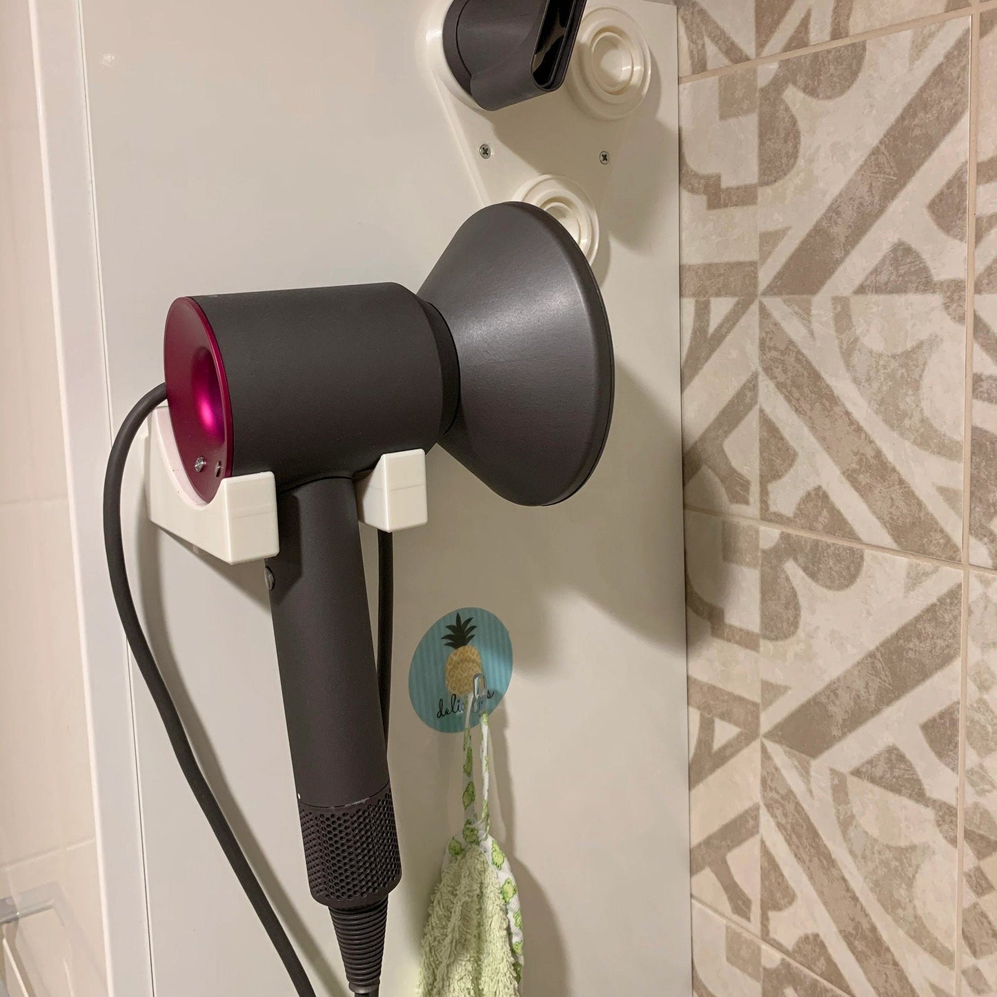 a hair dryer sitting on top of a wall next to a hair dryer