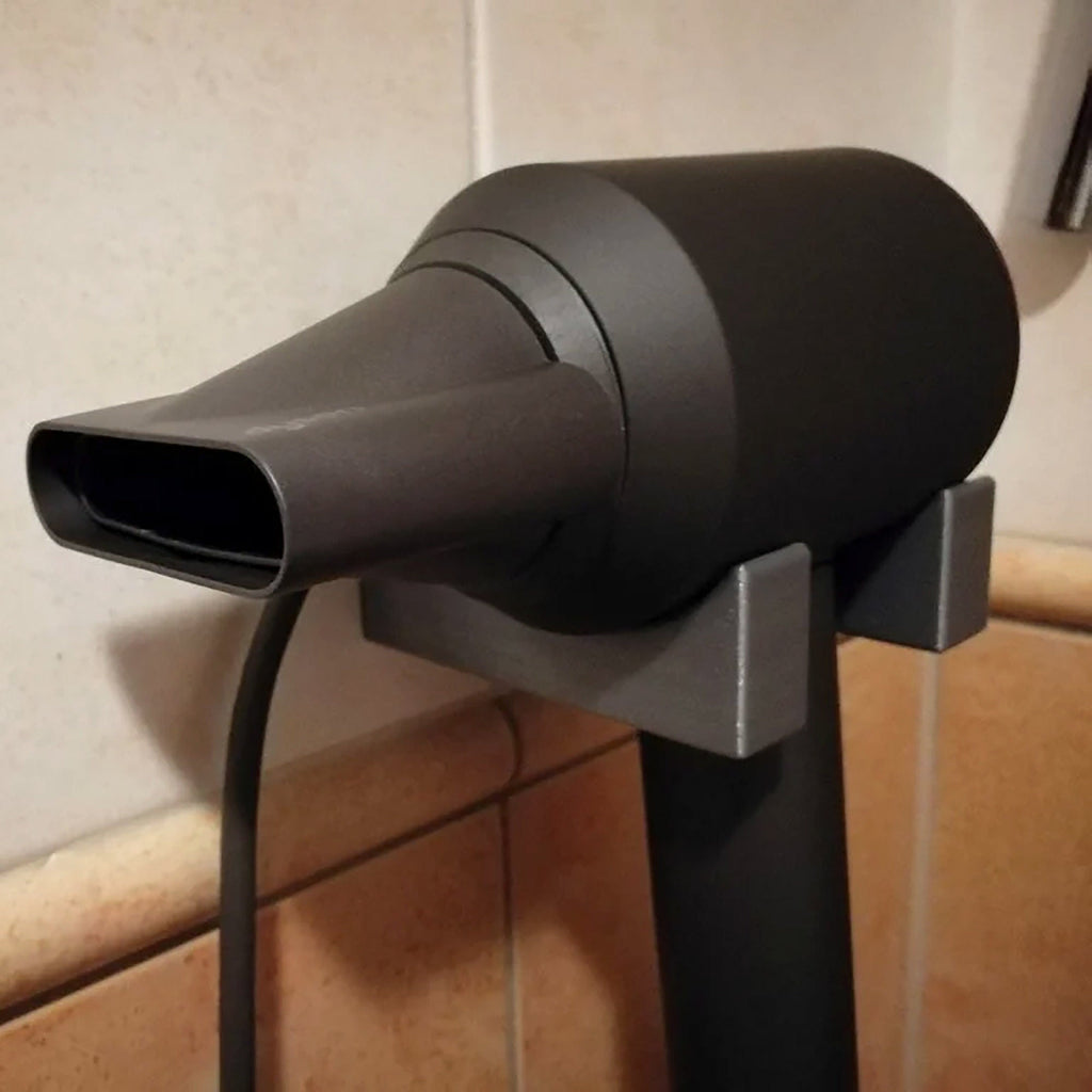Bathroom wall mount holder for Dyson Supersonic hair dryer with cord routed down the wall