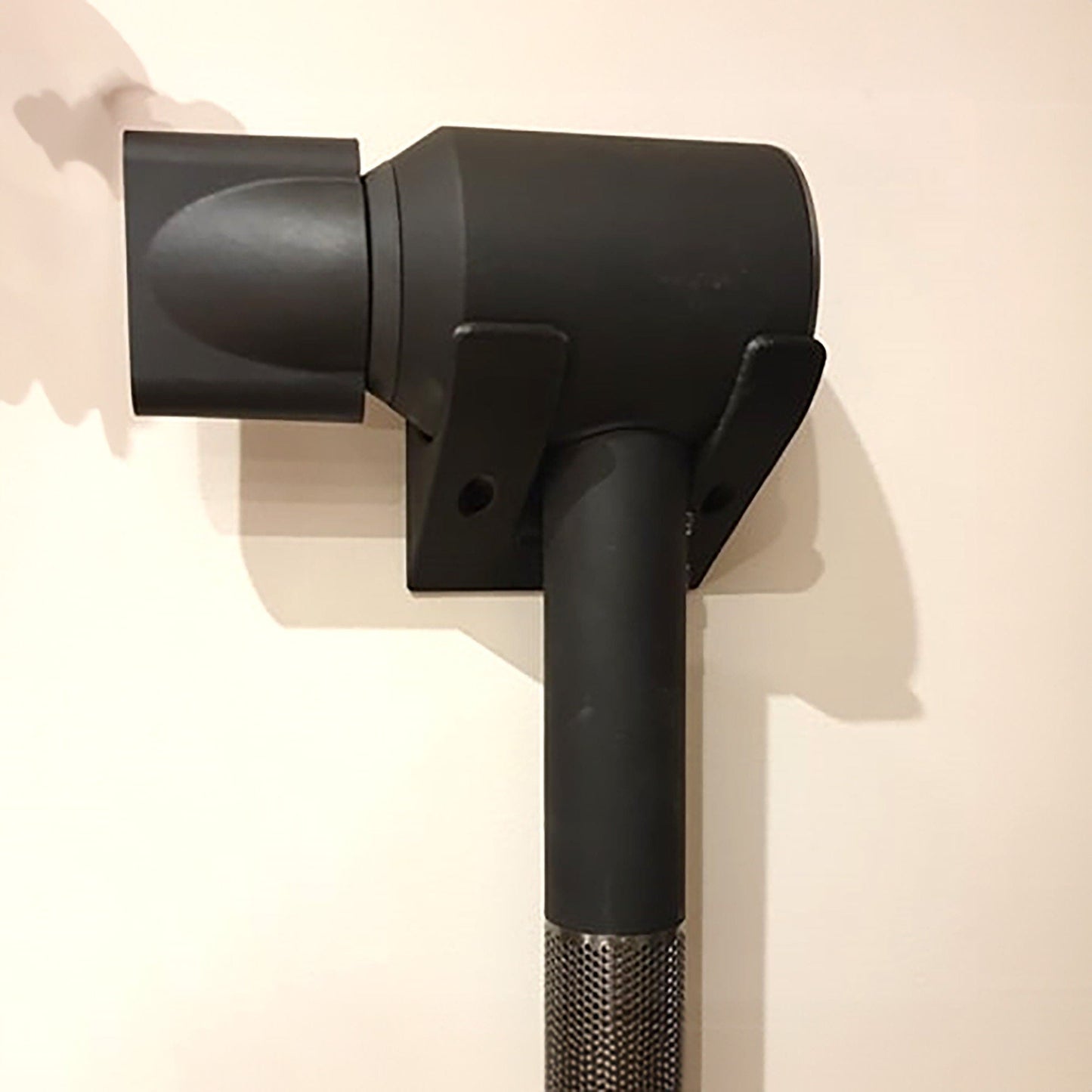 a close up of a black object on a wall