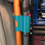 Storage clip holding a Dyson V7 or V8 stick vacuum wand upright on a broom handle, view 4